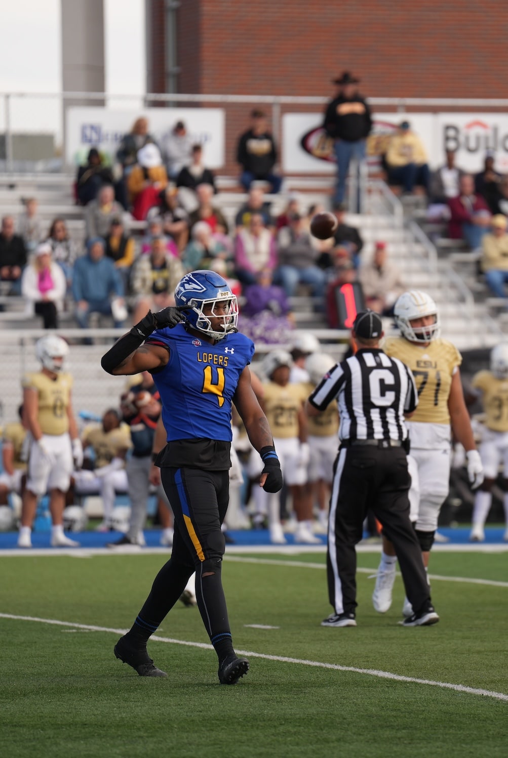 A UNK Football player points after the team advances.